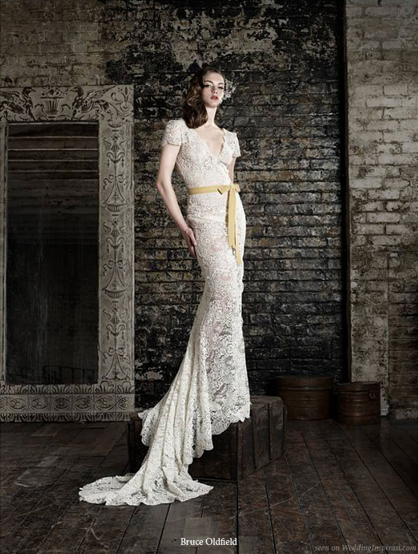 Lovely lace wedding gown with short or cap sleeves and train, worn with a mustard color sash at the natural waist