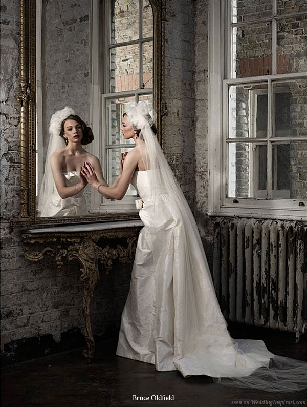Mirror image- bride models a strapless wedding dress designed by UK based designer Bruce Oldfield for his bridal collection