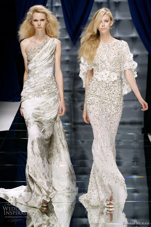 A shiny shade of white evening gowns -- one-shoulder and elbow length sleeves-- on models on the runway of Zuhair Murad Couture Fall/Winter 2010-2011 fashion show