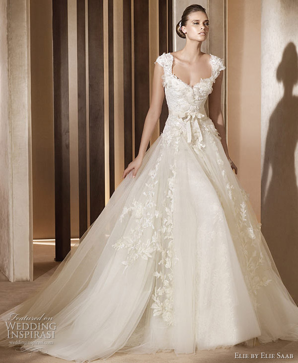 Above and below Aglaya cap sleeve wedding gown We adore this gown