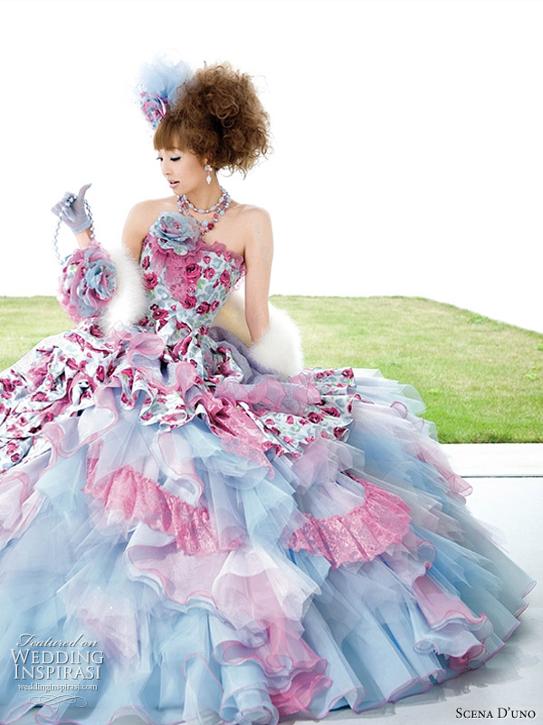 Colorful wedding dress in light blue with pink ruffles and fuchsia flower