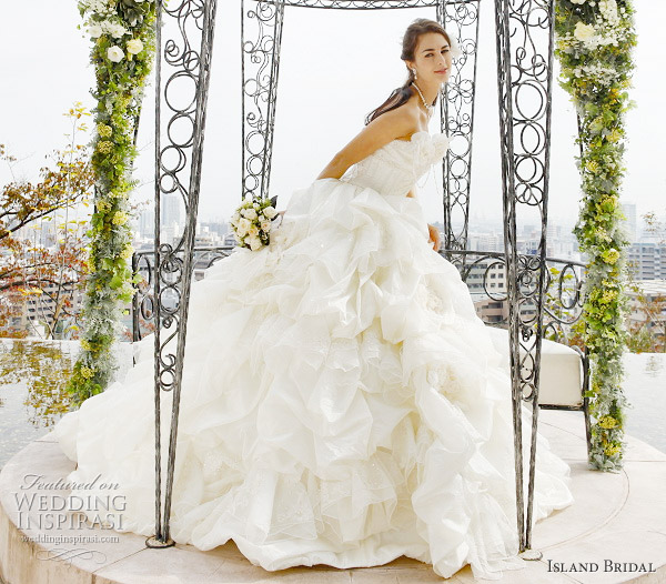 Sweet wedding gown with pink floral accents on the skirt and strap