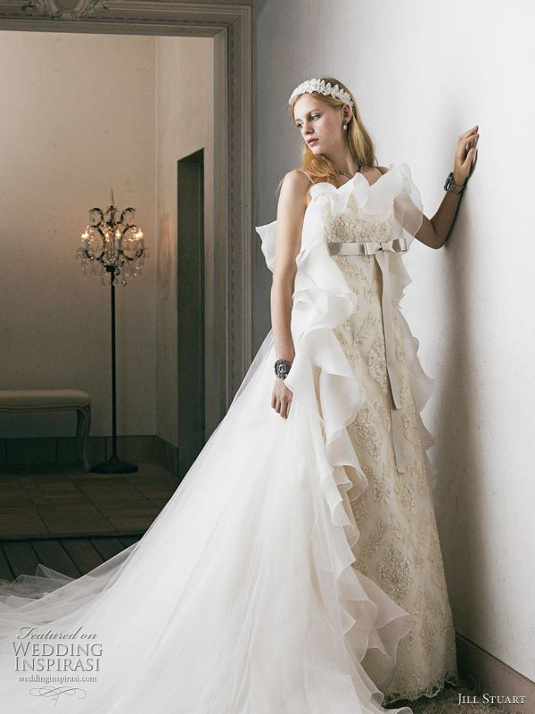 Gorgeous offwhite wedding dress accented with bow at waist and cascading 