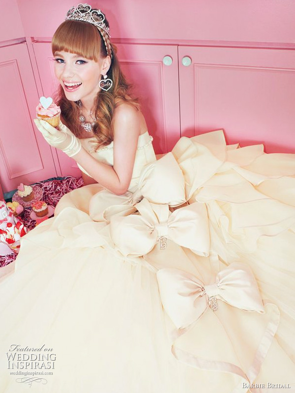 Cute as a cupcake strapless ivory dress with a row of fluffy bows on the 