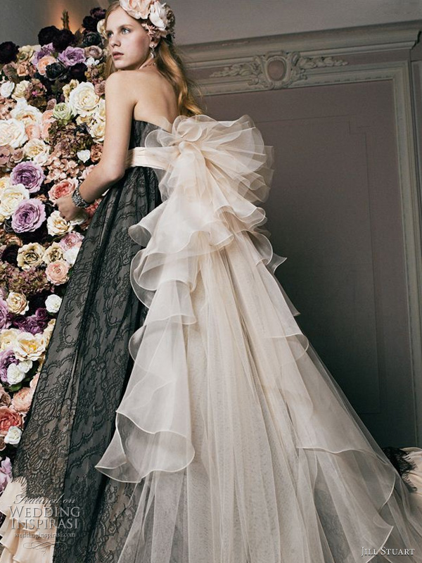 Ruffled bustle adds a dramatic touch to a soft pink gown with black lace 