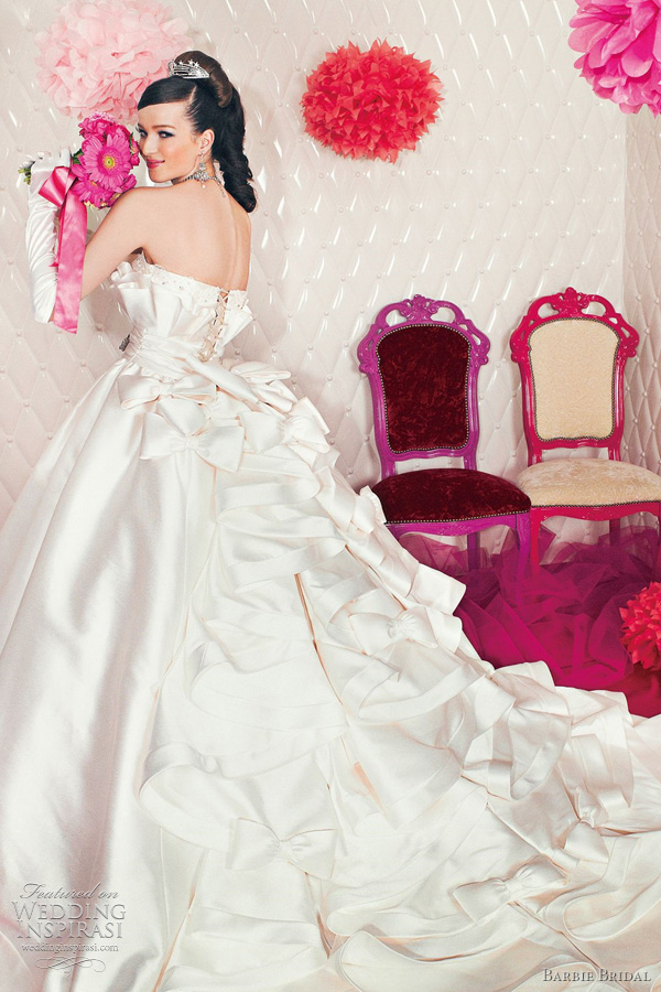 Adorable wedding dress with gathered skirt and bows adorning the straps