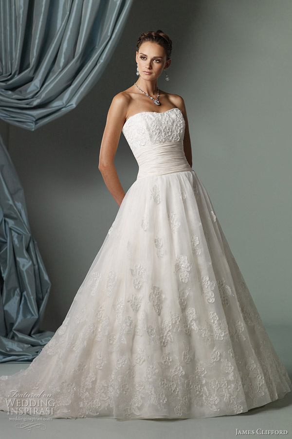 Below strapless ball gown with lace bodice featuring ribbon trimmed flower