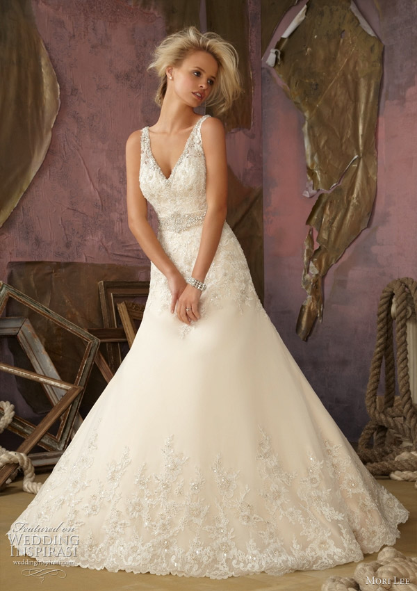 Strapless organza gown with ruffled skirt and crystal beading.