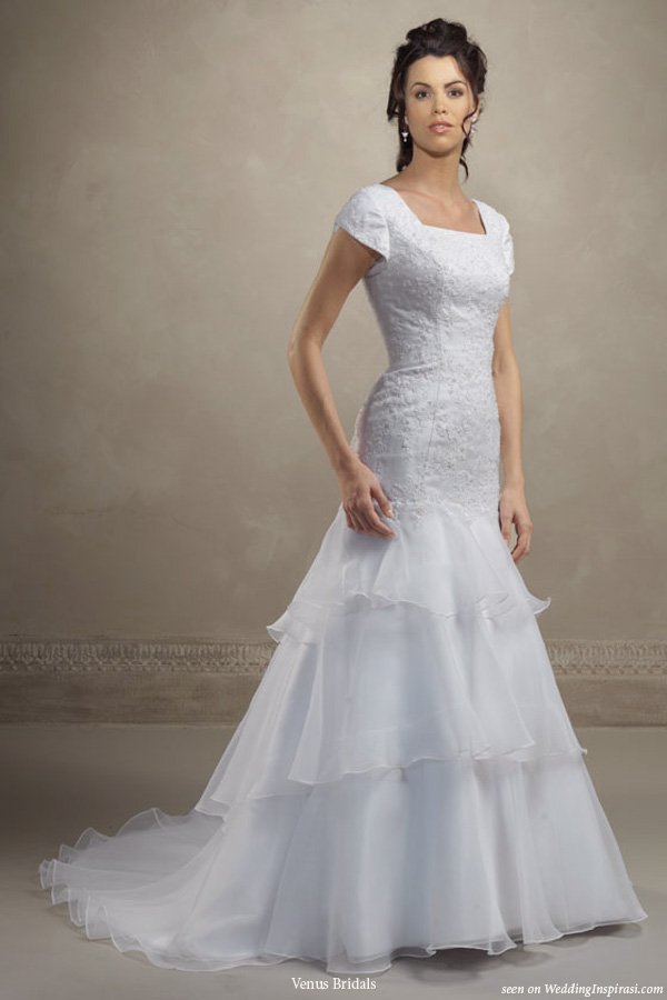 Beautiful wedding dress for modest brides - Mermaid gown has square neckline, beaded lace applique, petal sleeve, layers of organza ruffle at hem, zipper back with covered buttons. by Venus Bridals