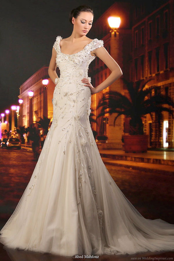 Wedding bridal gown with thick straps, slightly off-shoulder and fit and flare slight mermaid silhouette