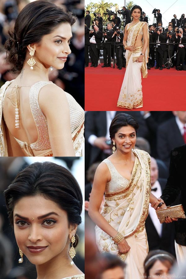 Indian model and actress Deepika Padukone in a sexy ivory sari with gold detail designed by Rohit Bal at the red carpet of Cannes Film Festival 2010