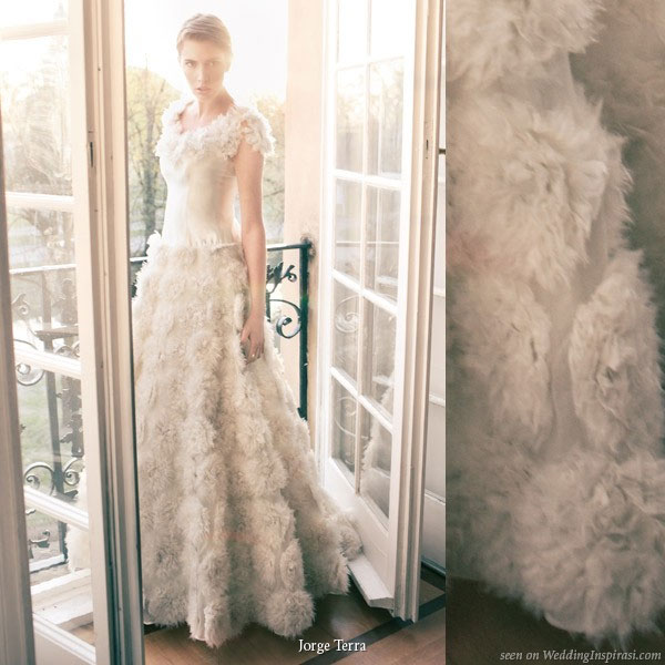 Ethereal light at this photo shoot showing a gorgeous feather ruffle wedding gown by Jorge Terra