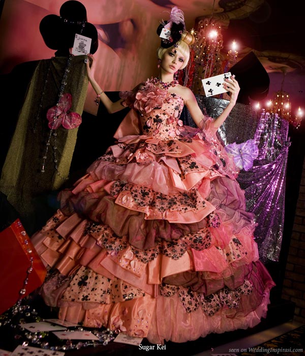 Alice in Wonderland wedding theme photo shoot with cards, coral, salmon pink and brown ruffle bridal gown