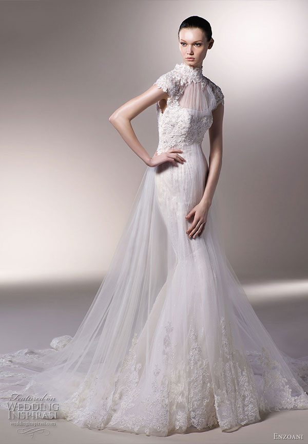 Emily wedding gown -  French chantilly lace over layered tulle with empire waistline. Illusion cap sleeves over a slight sweetheart neckline with lace, scattered beading and Swarovski crystals; cathedral train. From Enzoani 2010 bridal dress collection