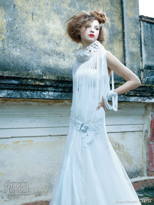 Inmaculada Garcia 2011 wedding dress collection - bridal gown with funnel neck collar and fringe like drapes over strapless frock