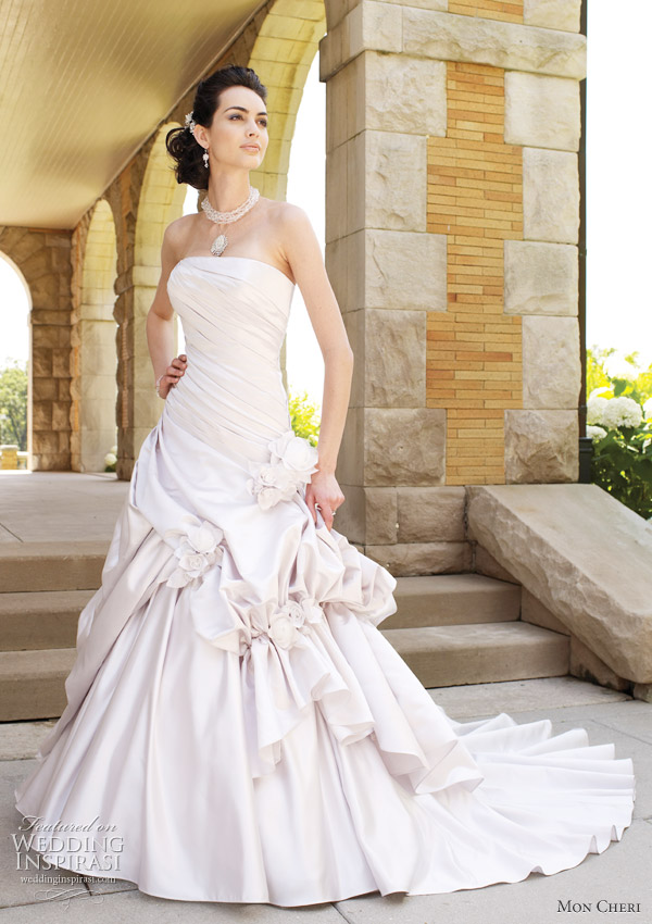 Mon Cheri Opal wedding dress - strapless satin ball gown, directionally pleated bodice with asymmetrically dropped waistline, dramatic pick-up skirt pinched with three-dimensional handmade satin and organza flowers, chapel length train, detachable spaghetti and halter straps included.