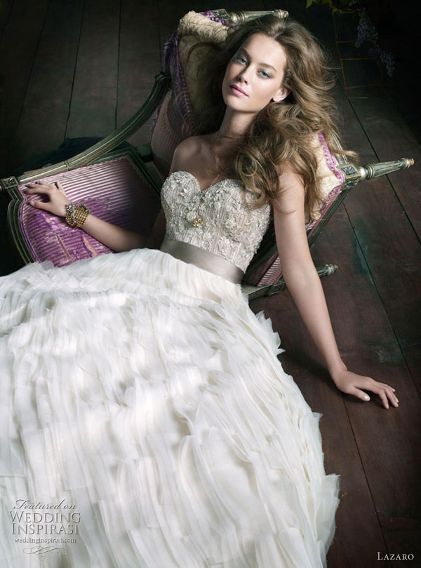 Lazaro Wedding Gown Fall 2010 - 2011 collection: Ivory organza tufted ball bridal gown, sweetheart neckline, sheer jewel encrusted bodice with platinum silk satin ribbon at natural waist, tufted organza A-Line skirt, chapel train. Lazaro Wedding Gown Fall 2010 - 2011 collection: Ivory organza tufted ball bridal gown, sweetheart neckline, sheer jewel encrusted bodice with platinum silk satin ribbon at natural waist, tufted organza A-Line skirt, chapel train.