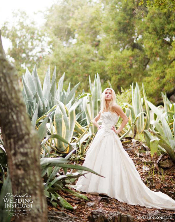 Benjamin Roberts wedding gowns 2011 bridal collection - A line gown with a softly shaped plain neckline and a large swathe of frayed fabric vintage looking roses on the one hip.