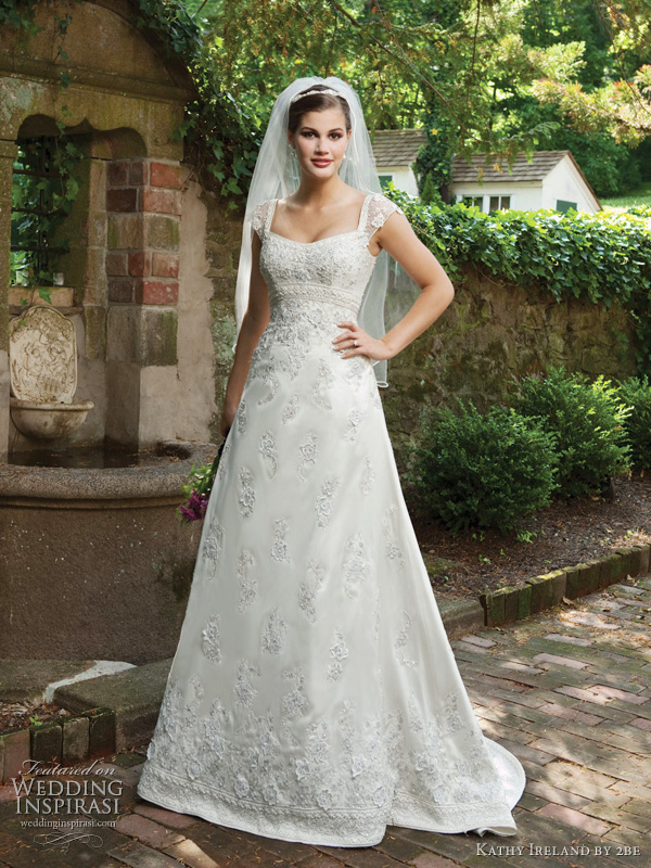 2be Bridals Spring 2011, Kathy Ireland collection - Style I231101S Intricately hand-beaded silk Dupioni A-line gown with beaded illusion cap sleeves, softly curved neckline, beaded Empire waistband, chapel length train. Also available in taffeta as I231101 in White and Ivory.