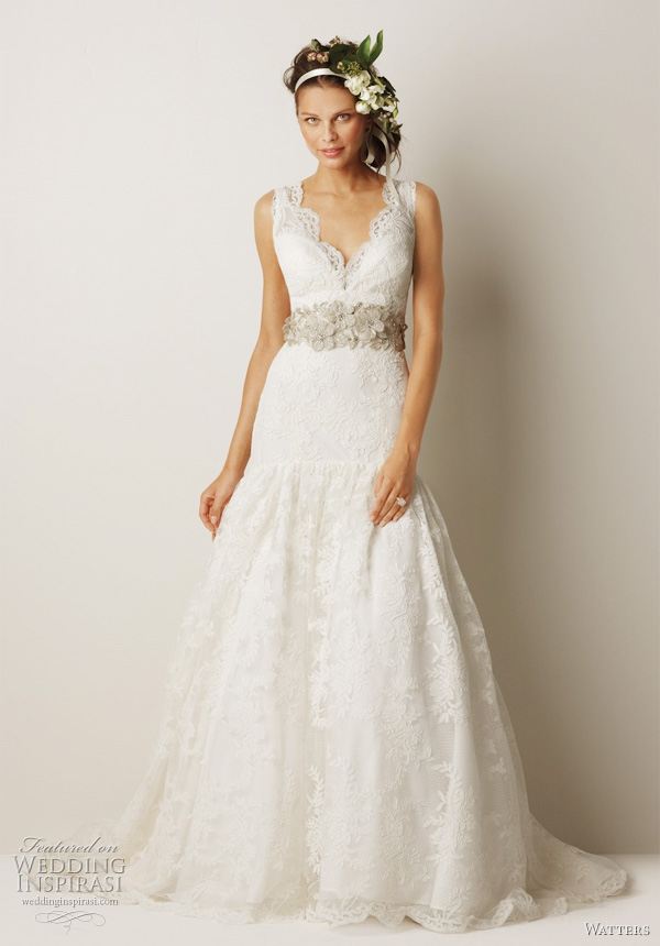 Watters bridal Fall 2011 collection wedding dress  -  Lithgow Ivory v-neck antique rose patterned, re-embroidered lace mermaid gown with full flounce at hip, and 69" chapel train. Shown with belt style 8003B (sold separately). 