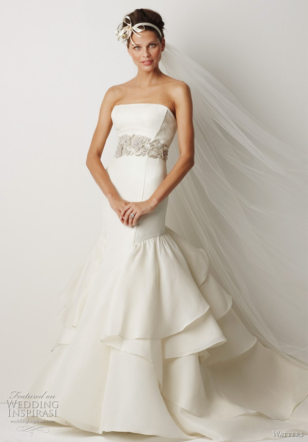 Watters Bridal Fall 2011 collection - Canberra Ivory silk gazar sculpted strapless gown with fit and flare silhouette and dramatic layered ruffle back skirt, 62" sweep train. Shown with belt style 8003B (sold separately). Watters Bridal Fall 2011 collection - Canberra Ivory silk gazar sculpted strapless gown with fit and flare silhouette and dramatic layered ruffle back skirt, 62" sweep train. Shown with belt style 8003B (sold separately).