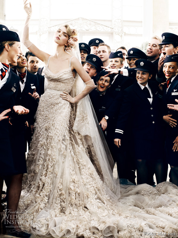 elie saab wedding dress mario testino - model Arizona Muse in an embroidered tulle and lace gown with draped bust, flower applique and grosgrain belt with tulle veil by Elie Saab haute couture, surrounded by British Airways pilots and cabin crew, shot by photographer Mario Testino for Vogue UK Royal Wedding Issue May 2011