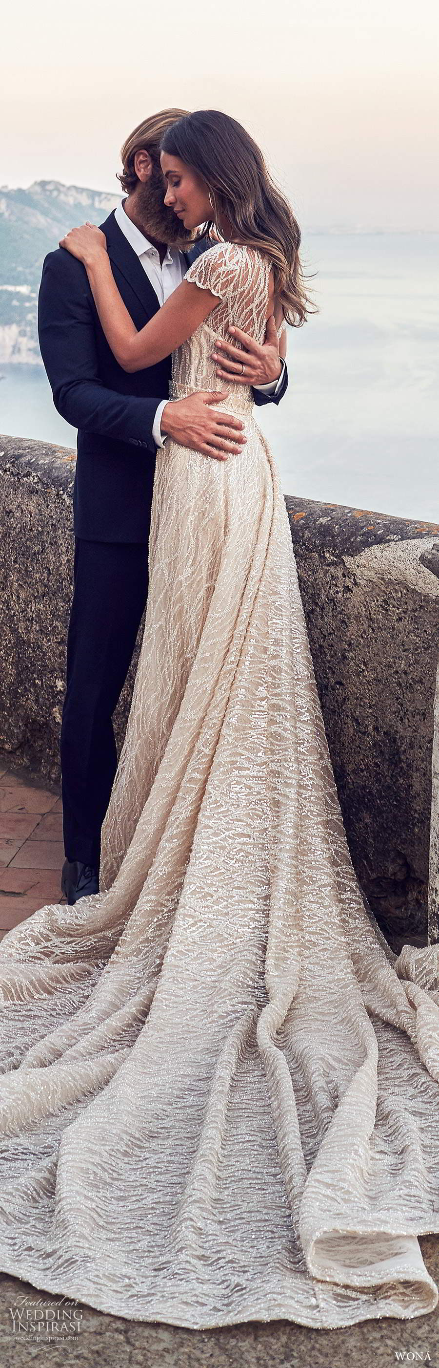 wona fall 2020 bridal illusion cap sleeves sheer bateau neckline fully embellished glitzy sheath wedding dress a line overskirt chapel train (20) bv wona fall 2020 bridal illusion cap sleeves sheer bateau neckline fully embellished glitzy sheath wedding dress a line overskirt chapel train (20) bv