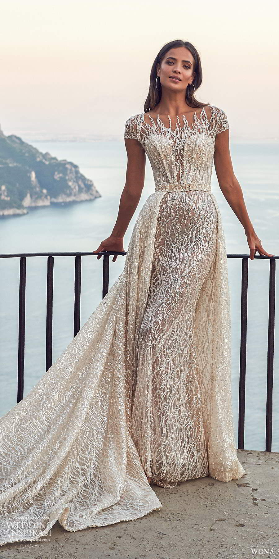 wona fall 2020 bridal illusion cap sleeves sheer bateau neckline fully embellished glitzy sheath wedding dress a line overskirt chapel train (20) mv