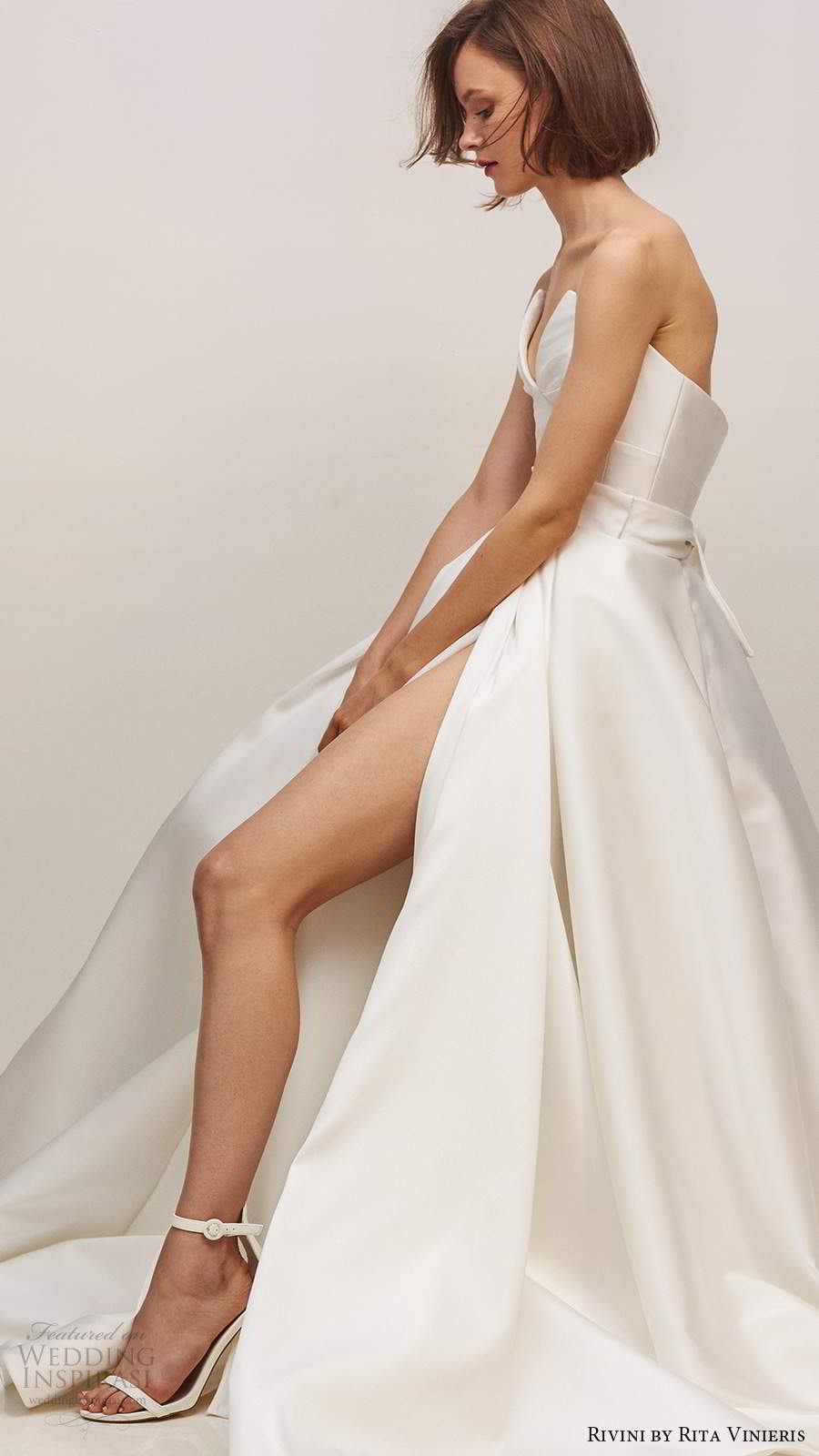 rivini by rita vinieris fall 2020 bridal strapless split neckline clean minimalist a line ball gown wedding dress slit skirt chapel train (7) mv