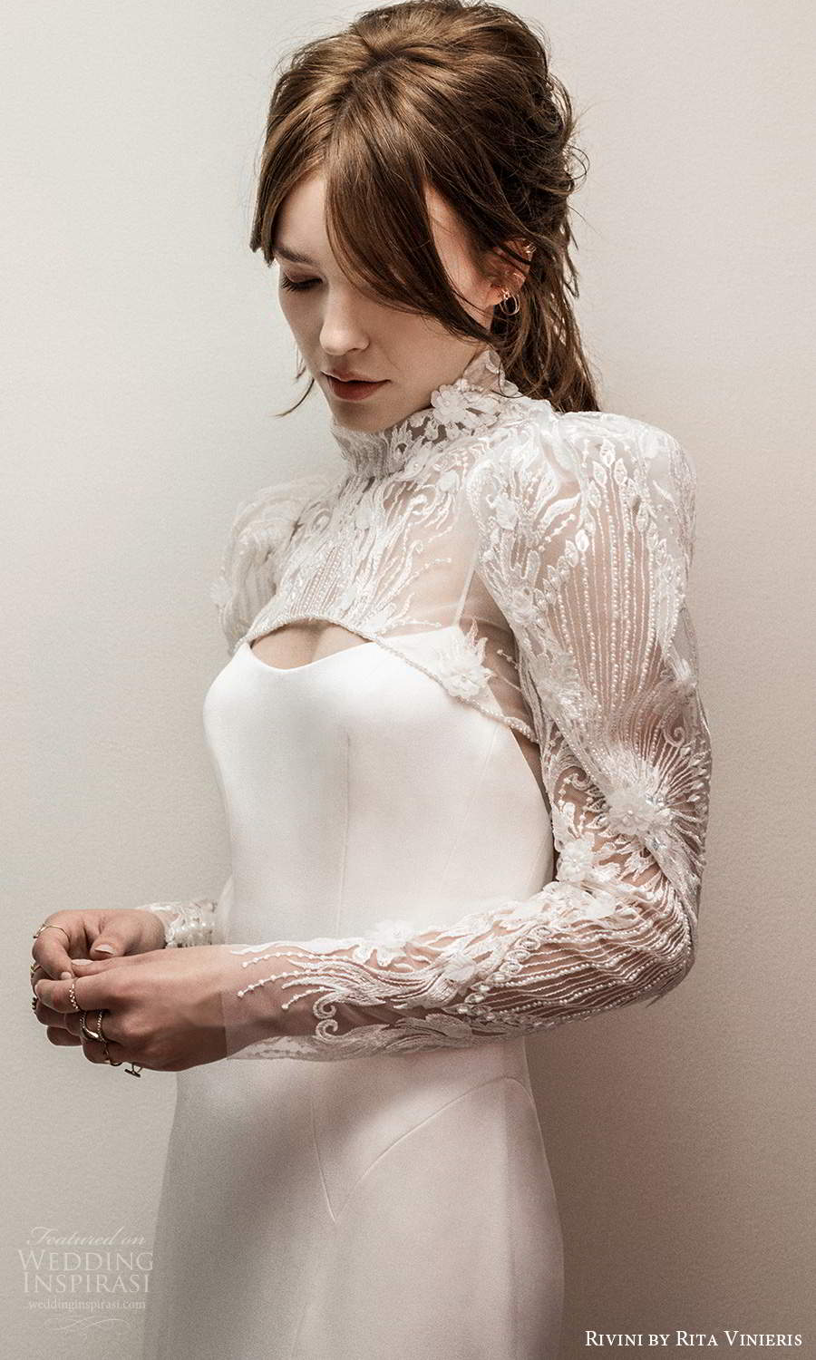 rivini rita vinieris fall 2021 bridal long puff sleeve high neck jacket sleeveless thin straps scoop neckline clean minimalist sheath wedding dress chapel train (7) zv rivini rita vinieris fall 2021 bridal long puff sleeve high neck jacket sleeveless thin straps scoop neckline clean minimalist sheath wedding dress chapel train (7) zv