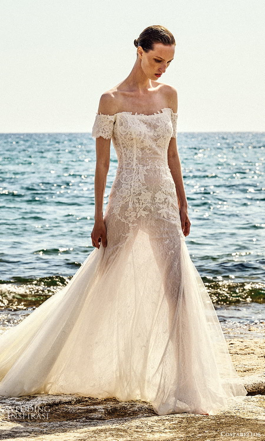 costarellos spring 2022 bridal off shoulder short sleeves straight across neckline fully embellished lace fit flare mermaid wedding dress chapel train (2) mv costarellos spring 2022 bridal off shoulder short sleeves straight across neckline fully embellished lace fit flare mermaid wedding dress chapel train (2) mv