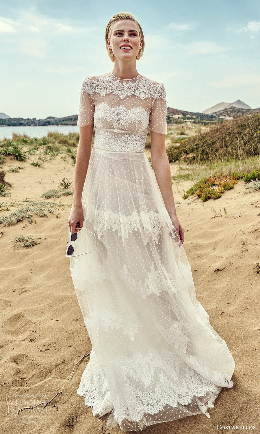 costarellos spring 2022 bridal short sleeve plunging scalloped v neckline fully embellished lace trumpet sheath wedding dress sweep train slit skirt (9) mv costarellos spring 2022 bridal short sleeve plunging scalloped v neckline fully embellished lace trumpet sheath wedding dress sweep train slit skirt (9) mv