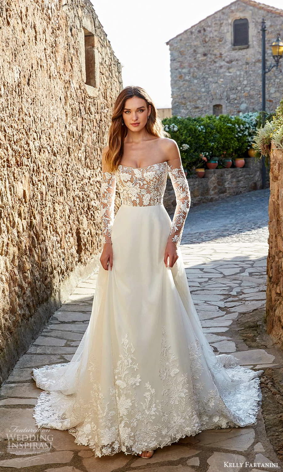 kelly faetanini spring 2022 campaign bridal off shoulder long sleeve semi sweetheart neckline embellished lace bodice clean skirt a line wedding dress chapel train (16) mv