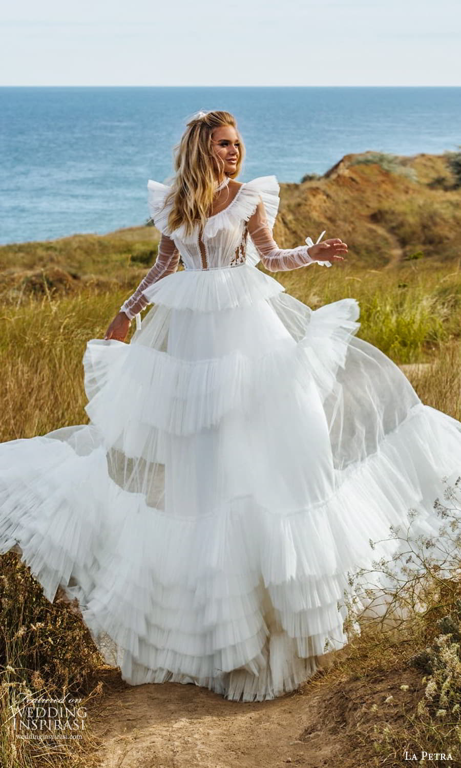 la petra 2021 bridal sheer long sleeve flutter illusion jewel neckline tiered skirt a line ball gown wedding dress chapel train (8) fv