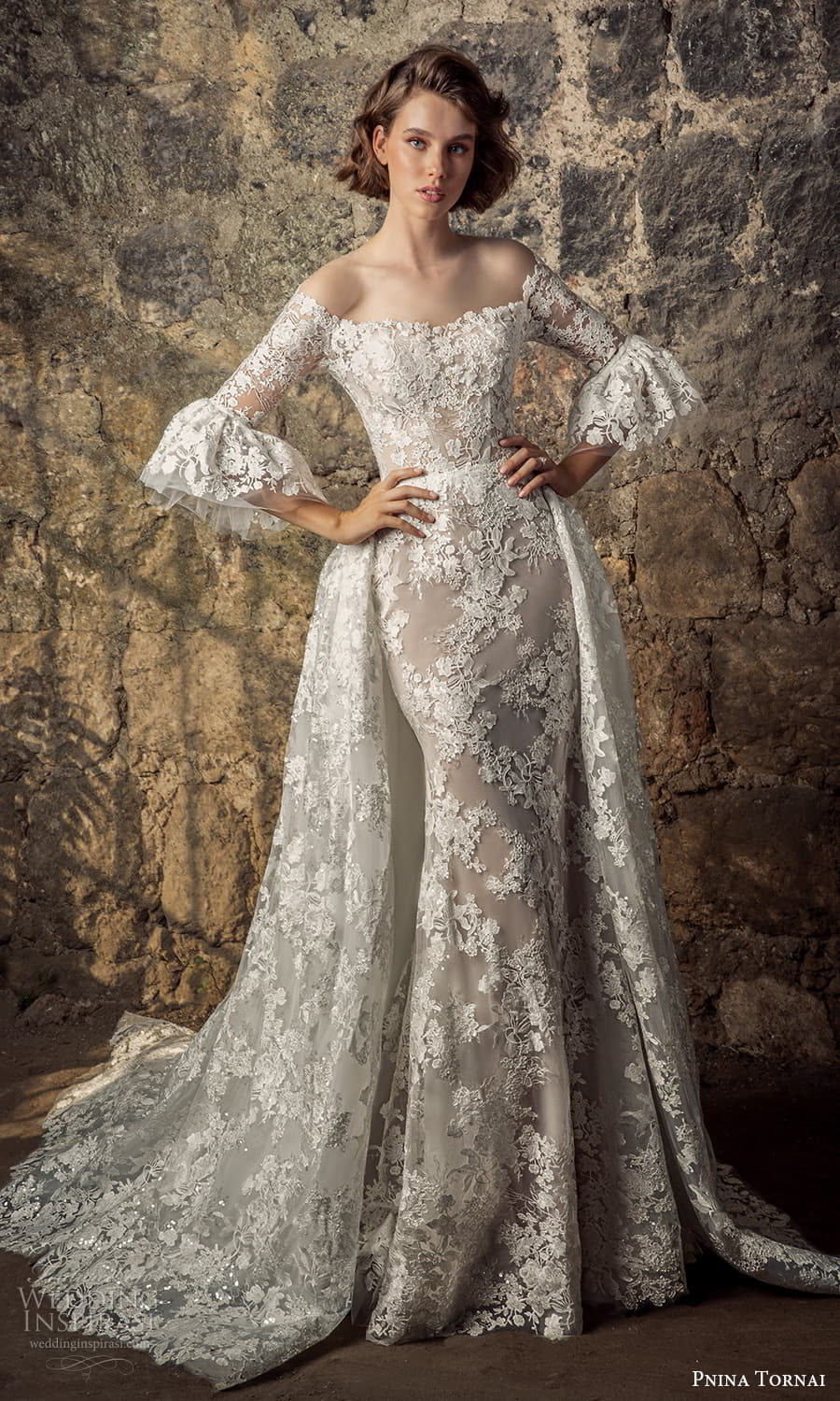 pnina tornai 2021 bridal 3 quarter flare sleeve off shoulder neckline fully embellished lace sheath wedding dress a line overskirt chapel train (13) mv pnina tornai 2021 bridal 3 quarter flare sleeve off shoulder neckline fully embellished lace sheath wedding dress a line overskirt chapel train (13) mv