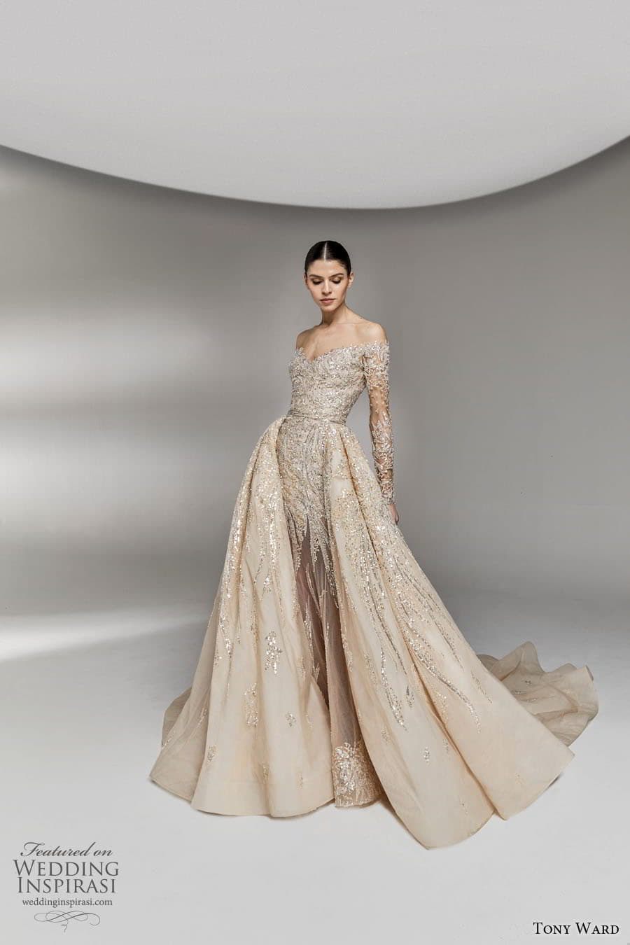 tony ward spring 2023 bridal sheer long sleeve off shoulder neckline fully embellished sheath wedding dress a line overskirt chapel train (13) mv