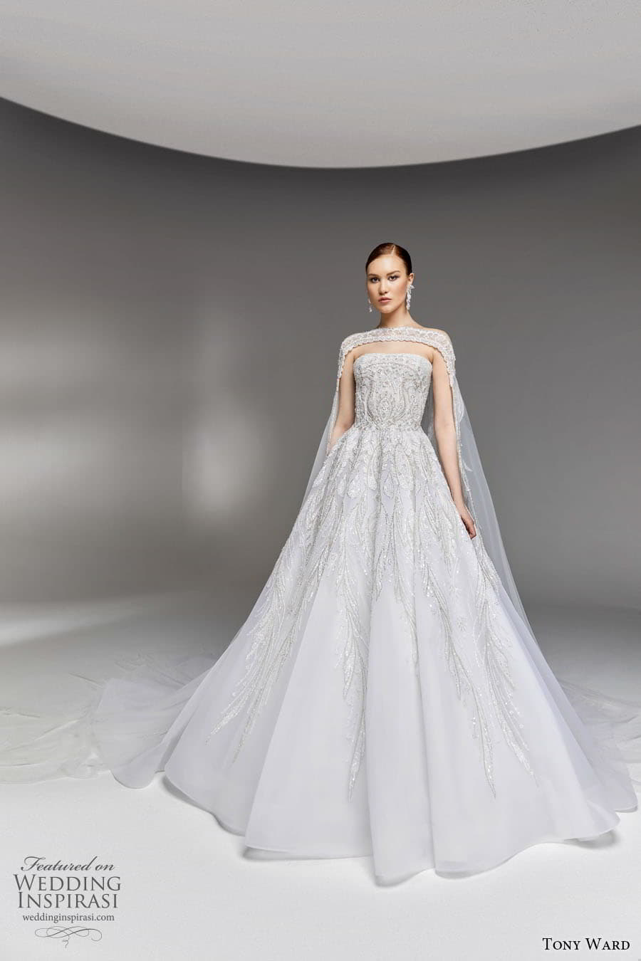 tony ward spring 2023 bridal strapless straight across neckline fully embellished a line ball gown wedding dress chapel train sheer cape (1) mv