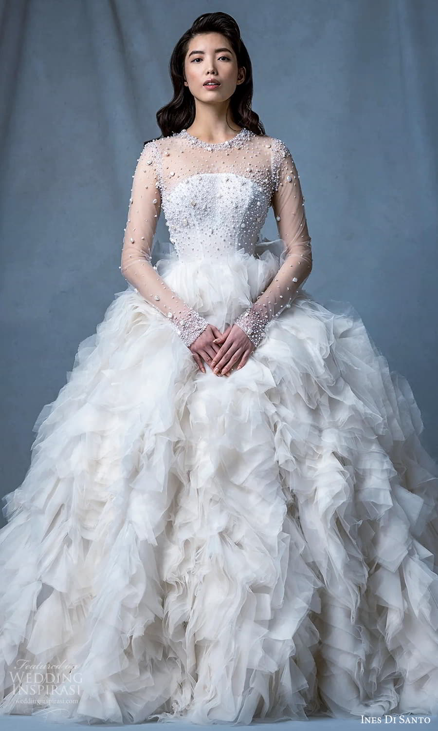 ines di santo fall 2024 bridal sheer long sleeves illusion jewel neckline heavily embellished bodice a line ball gown wedding dress ruffle flange skirt chapel train (3) mv